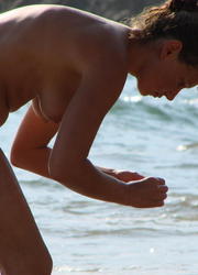 A busty bikini slut undressing on the Hanauma Image 2