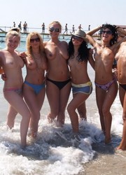 A busty bikini babe undressing on the Hanauma Image 3