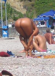 A girl removing her micro bikini at the Mazo Image 7
