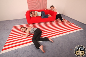 Sexy young gay has his clean anus double drilled by two horny gays on a new red sofa. Image 1