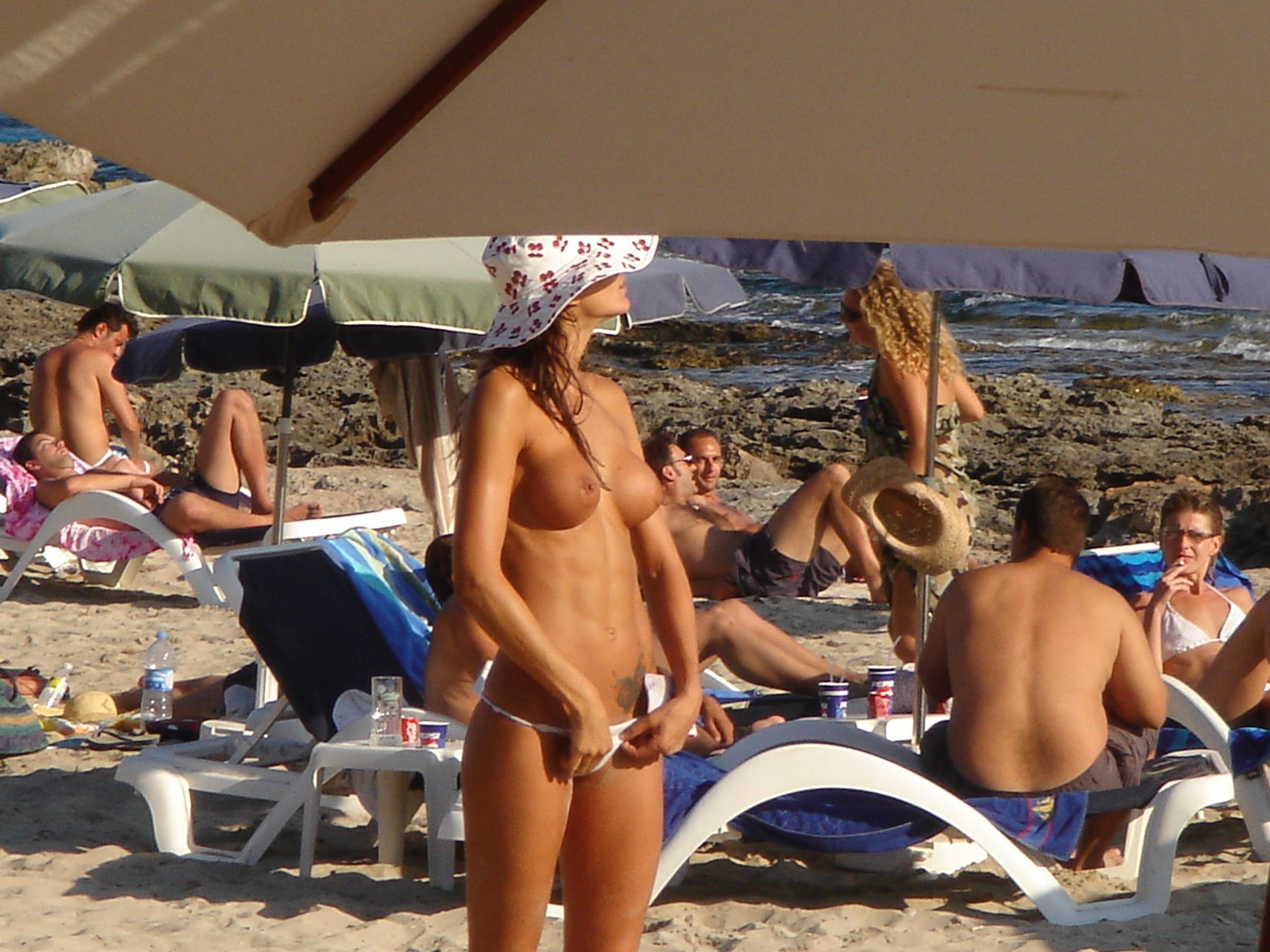 A bikini cutie going topless on the Copacabana