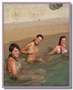 lazy young damsels disclaims swimwear on a bare beach